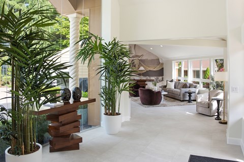 A living room with a white couch and a wooden table.