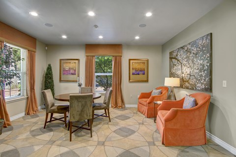 A living room with a table and chairs.