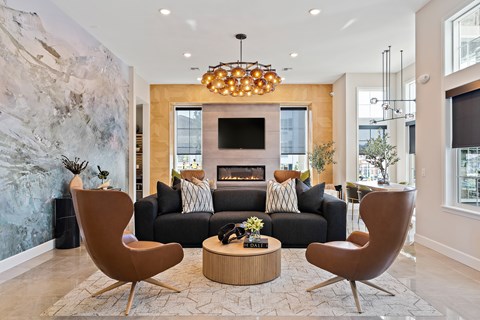 A living room with a fireplace and a large painting on the wall.