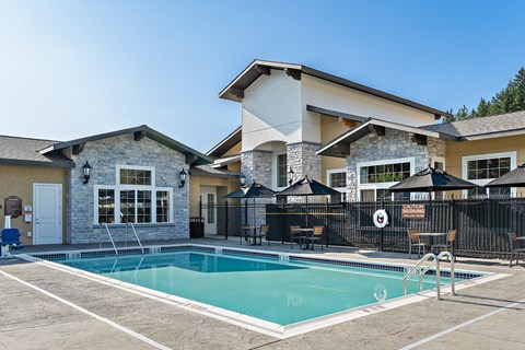 A house with a pool in front of it.