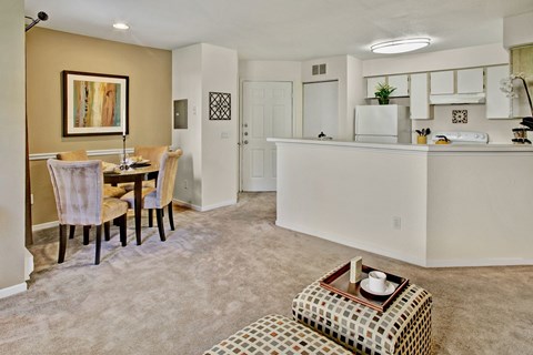 A kitchen and dining area with a table and chairs.