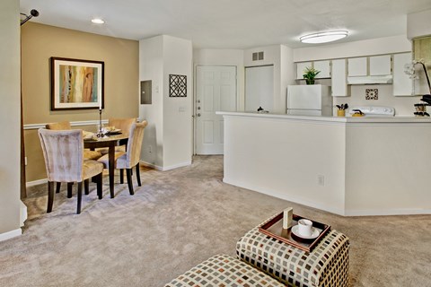 A kitchen and dining room with a table and chairs.