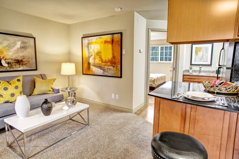 A living room with a grey couch and a white coffee table.