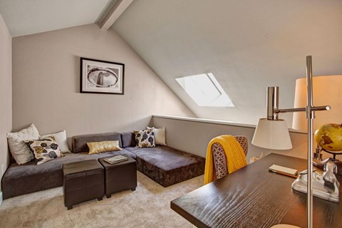A living room with a brown couch and a brown coffee table.