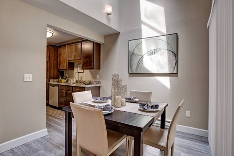 A dining room with a table set for two.