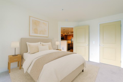 A bedroom with a large bed and a painting on the wall.