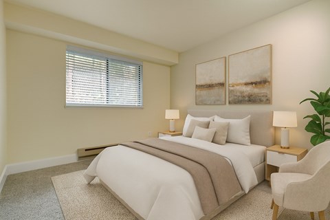 A bedroom with a large bed and a chair.