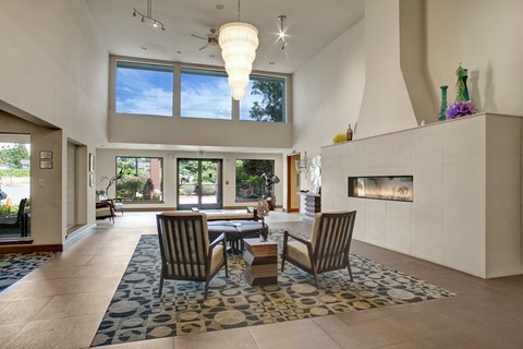 A modern living room with a fireplace and a dining table set up.