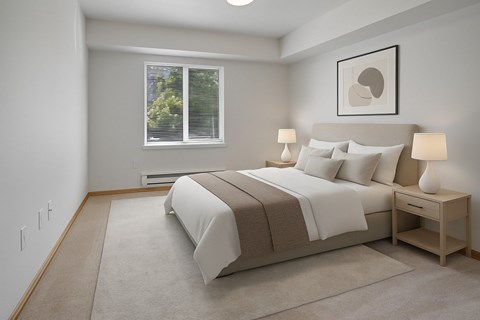 A bedroom with a large bed and a window with blinds.