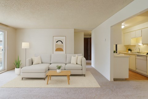 A living room with a white couch and a coffee table.