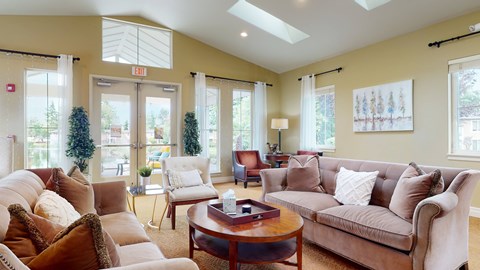 A living room with a brown couch and a coffee table.