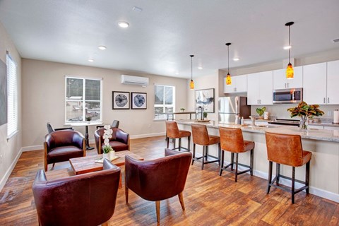 A kitchen with brown chairs and a white counter.