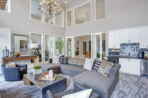 A modern living room with a grey sofa and a wooden coffee table.
