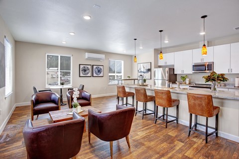 A kitchen with brown chairs and a white counter.