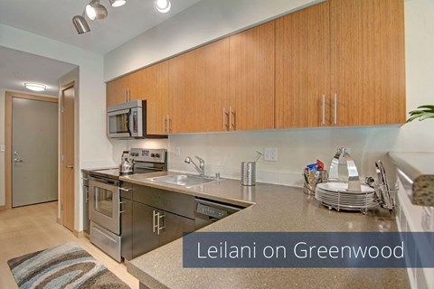 A kitchen with wooden cabinets and a stainless steel sink.