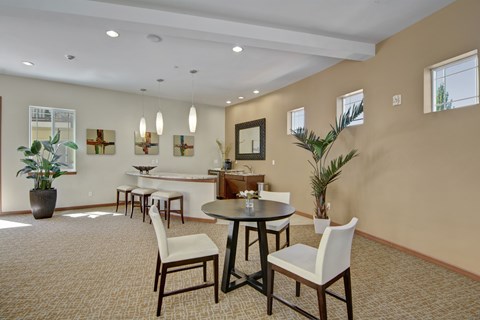 A dining room with a round table and chairs.