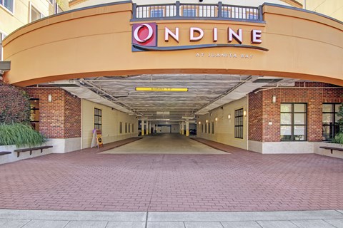The entrance to a building with a sign that reads "ONDINE at Juanita Bay.".