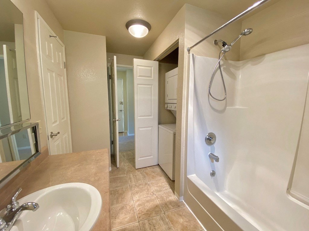 a bathroom with a shower and a sink