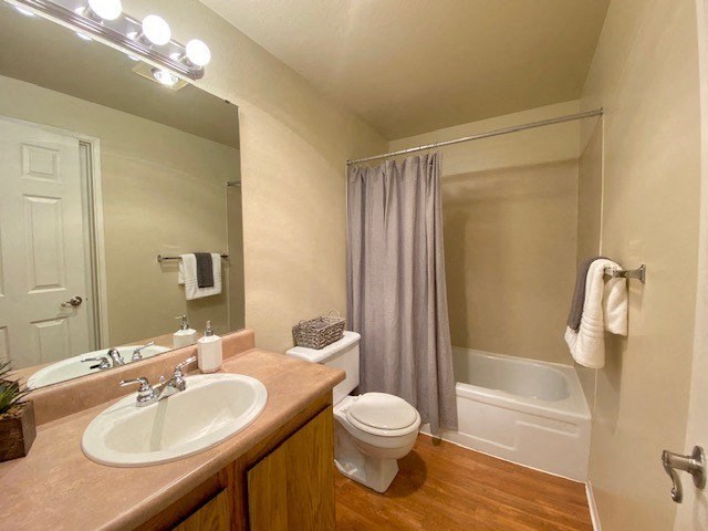 A bathroom with a toilet, sink, and shower.