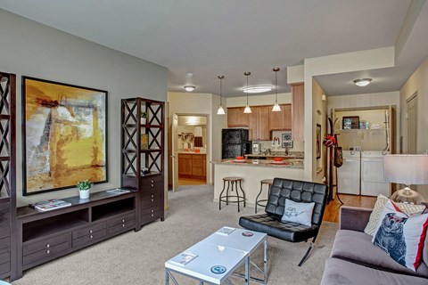 A living room with a black leather chair and a coffee table.