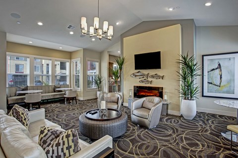 A living room with a fireplace and a television mounted on the wall.