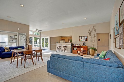 A blue couch is in the middle of a living room.