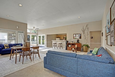 A blue couch is in the middle of a living room.