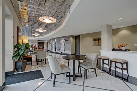 A modern dining room with a round table and chairs.