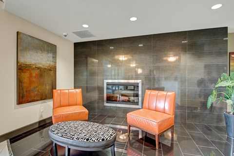 A living room with a painting on the wall and a television.