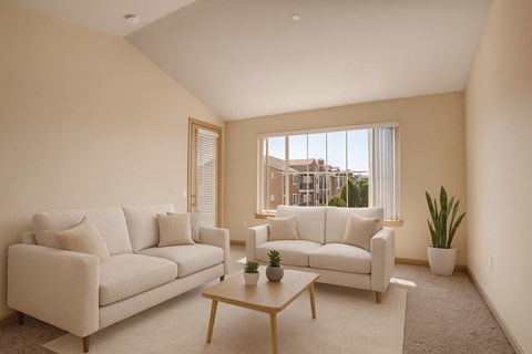 A living room with two white couches and a coffee table.