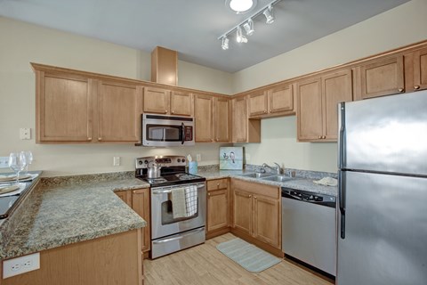 A kitchen with wooden cabinets and stainless steel appliances.