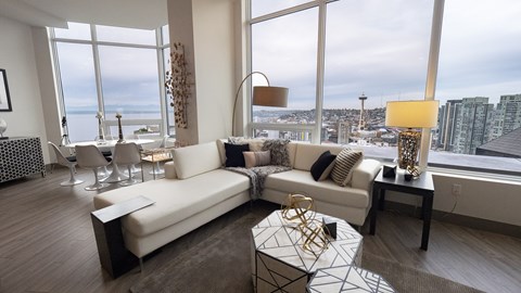 A modern living room with a large window overlooking the city.