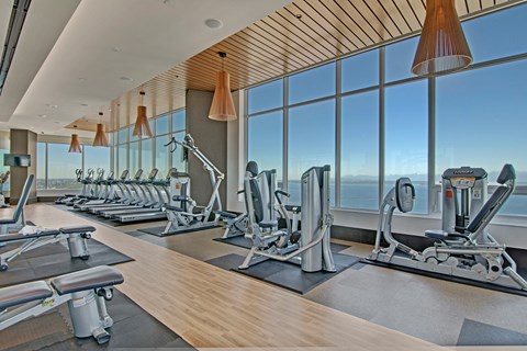 A gym with a view of the city skyline.