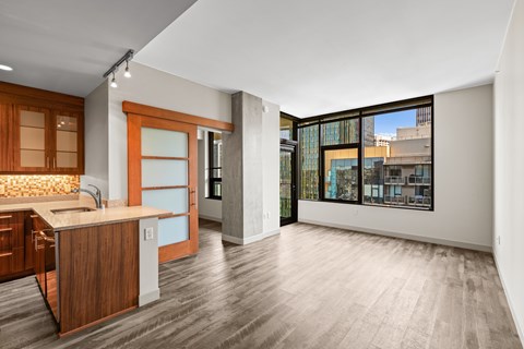 A kitchen with wooden cabinets and a countertop with a sink.