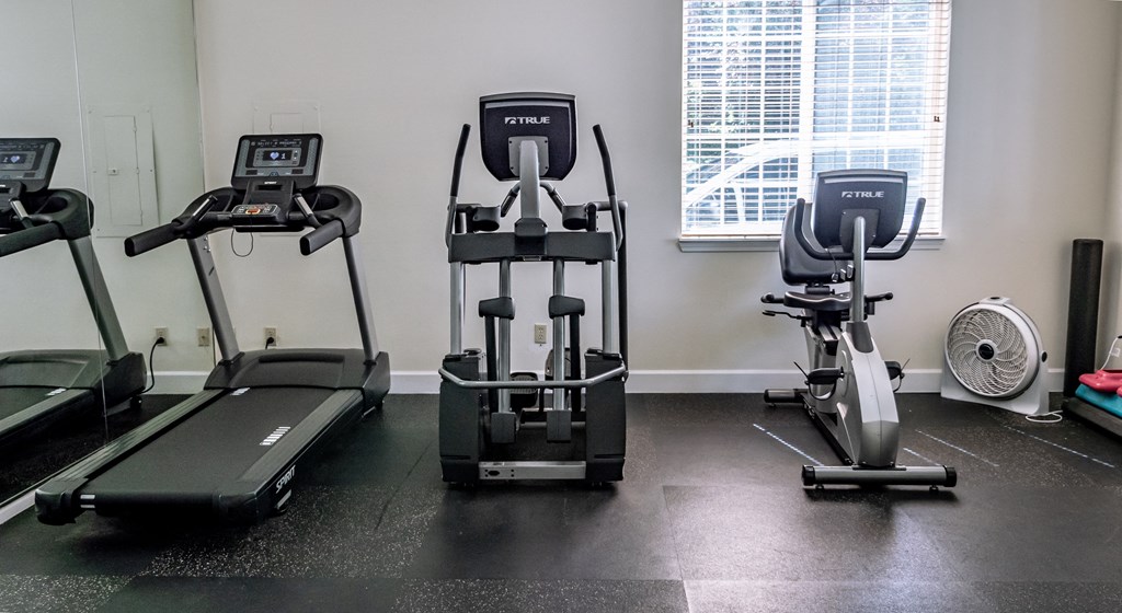 a row of exercise bikes in a gym