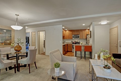 A modern living room with a dining table and chairs.