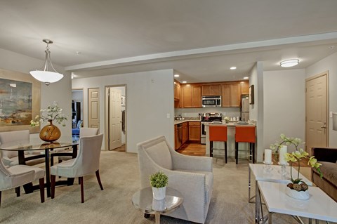A modern living room with a dining table and chairs.