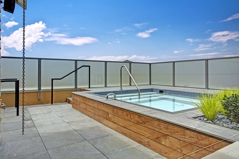 A small pool with a glass fence around it.