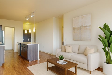 A living room with a white couch and a wooden coffee table.