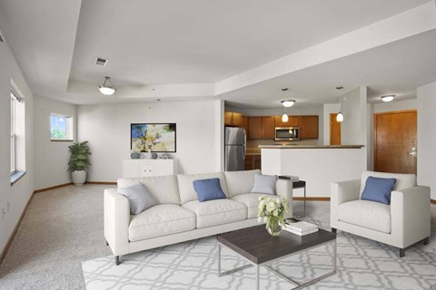 A living room with a white couch, a coffee table, and a painting on the wall.