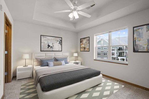 A bedroom with a large bed and a ceiling fan.