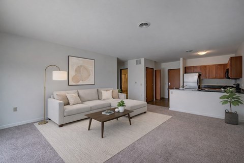 A living room with a white couch and a coffee table.
