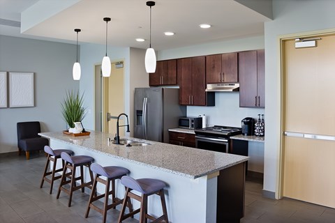A kitchen with a bar area and a chair.