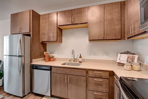 A kitchen with brown cabinets and a white refrigerator.