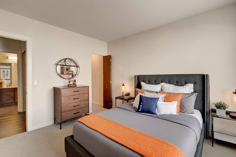 A bedroom with a large bed and a dresser.