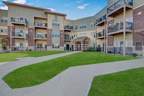 Apartment complex with a walkway in the foreground.