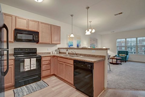 A kitchen with wooden cabinets and a black stove top oven.