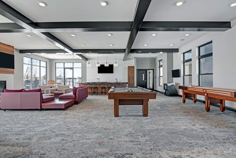 A modern living room with a grey carpet and a wooden coffee table.