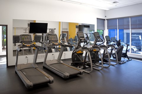 A gym with treadmills and exercise bikes.