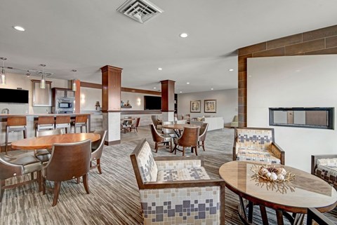 A modern dining room here at Vue at Pinnacle Park with a wooden table and chairs.